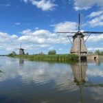 Amsterdam: Kinderdijk, Euromast, Delft and Den Haag Day Tour - Stroll Through Delft’s Picturesque Canals and Medieval Towers