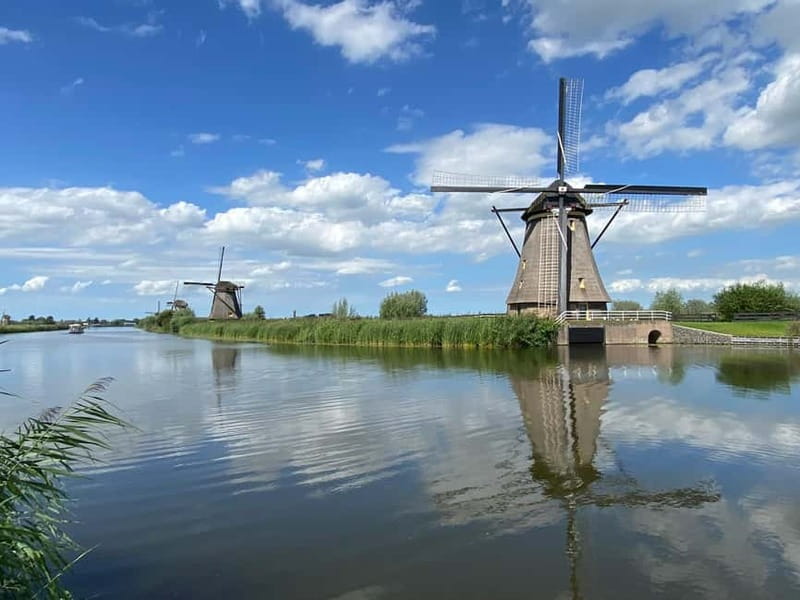 Amsterdam: Kinderdijk, Euromast, Delft and Den Haag Day Tour - Stroll Through Delft’s Picturesque Canals and Medieval Towers