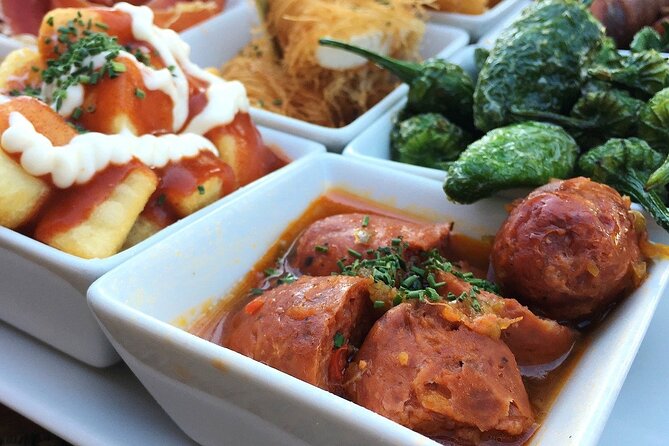 Barcelona Food Tour: Tapas, Drinks and Delights with a Local - Visiting Plaça de lÀngel and La Ramblas Surroundings