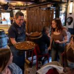 Barcelona Side Streets Tapas & Wine Tour - Iconic Tapas: Bomba de Barceloneta and Paella