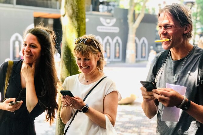 Discover Amsterdam's city center in this Outside Escape game tour - Visiting the Munttoren at a Bustling Square