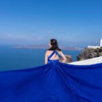 Dreamy Flying Dress Photoshoot in Santorini - Iconic Blue Dome as a Picturesque Backdrop