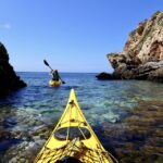 Favignana: kayak excursion, snorkelling and adventure - Starting Point on Favignanas Small Beach with a Yellow Off-Road Vehicle