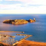 From Roses: Medes Islands Boat Tour with El Estartit Visit - Scenic Departure Across Roses Bay with Views of Montgrí Massif