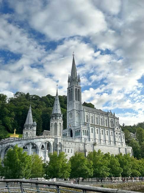 Lourdes Full day Guided Tour with Train Station Pickup - Exploring the Sanctuaries: Grotto, Basilicas, and Water Gestures