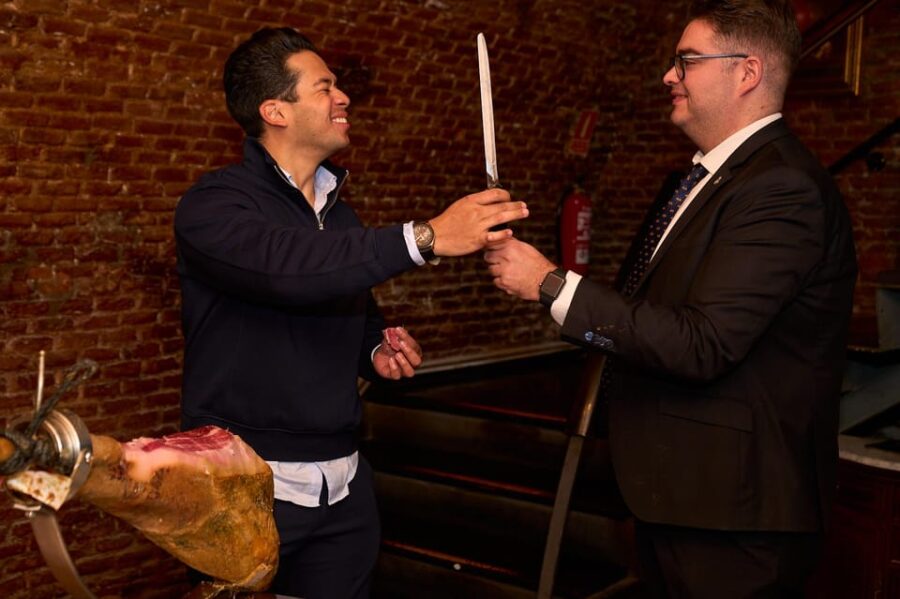 Madrid: Not Just Another Tapas & Wine Tour - Slicing Jamón Ibérico in an Authentic Cellar Setting