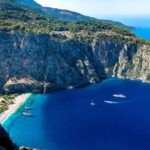Ölüdeniz: Blue Cave, Butterfly Valley & Lunch Boat Tour - Exploring Butterfly Valleys Cliff Enclosure