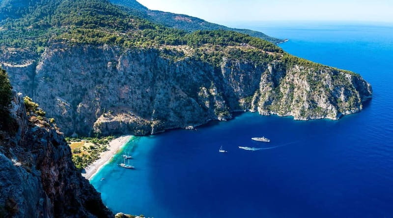 Ölüdeniz: Blue Cave, Butterfly Valley & Lunch Boat Tour - Exploring Butterfly Valleys Cliff Enclosure