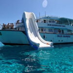 Paphos Blue Lagoon Cruise: Slide, Music & Hotel Transfer - The Blue Lagoon Swimming Stop and Waterslide Fun