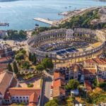 Rijeka: Pula, Rovinj, and Panoramic Istrian Coast Tour - Visiting Pulas Roman Amphitheater and Roman Monuments