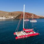 Sailing Catamaran Cruise in Santorini with BBQ, Drinks and Transfer - Cruising Along Santorinis Iconic Coastline