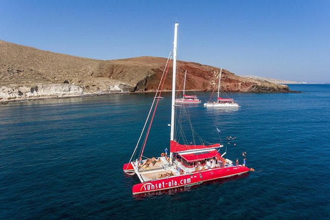 Sailing Catamaran Cruise in Santorini with BBQ, Drinks and Transfer - Cruising Along Santorinis Iconic Coastline