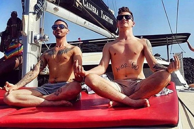 Santorini Adventurous Catamaran Experience with Snorkeling - Passing the Iconic Venetian Lighthouse and Black Mountain