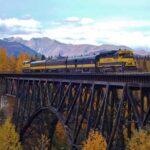 Alaska Railroad Anchorage to Denali One Way - Crossing the Knik River with the Chugach Mountains as a Backdrop