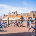 Amsterdam Small-Group Bike Tour With Canal Cruise, Drinks, Cheese - Visiting the De Gooyer Windmill and Its Cultural Importance