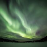 Northern Lights Hunt from Rovaniemi with Folk Tales and Snacks over Campfire - Keeping Warm Around the Campfire