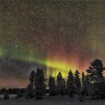 Northern Lights Hunting with Snowmobiles - Snowmobile Driving Through the Lappish Wilderness