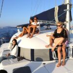 Santorini Half Day Catamaran Private Cruise incl. Meal, Drinks & Free Transport - Visiting the Santorini Lighthouse and Aspronisi Island