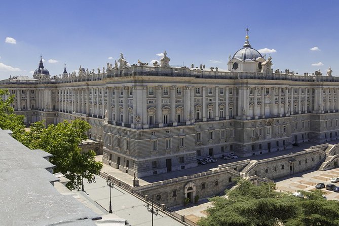 Skip-the-line Madrid Royal Palace with tapas tasting & Retiro Park - The Plaza de Isabel II and the Royal Palace Exterior